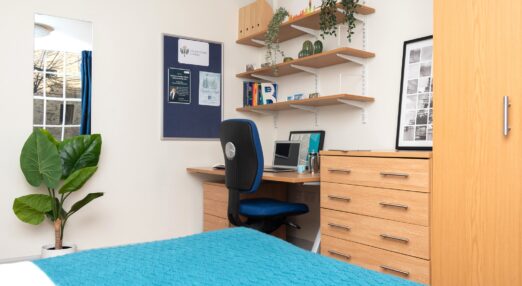 Typical bedroom, with study area and wardrobes, in a Goodenough College flat