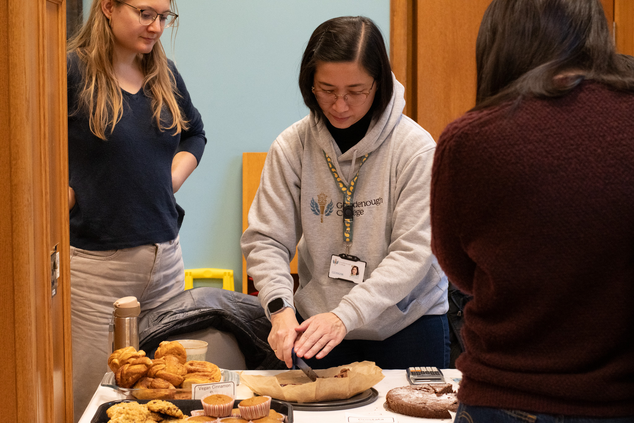 Goodenough Members selling baked goods during Goodenough Giving Day
